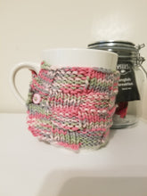 Load image into Gallery viewer, Sometimes you just need that warm drink in your favorite mug! Keep it warmer longer with a Mug Hug. These hand-knitted cozies will fit most standard size mugs. The embroidered style comes with two buttons, making it adjustable for several sizes, and the hand embroidered designs are one-of-a-kind. $5 each  Have a favorite color? Contact Cozy Up for custom orders at CozyUpByClaire@gmail.com! We'll be happy to work with you