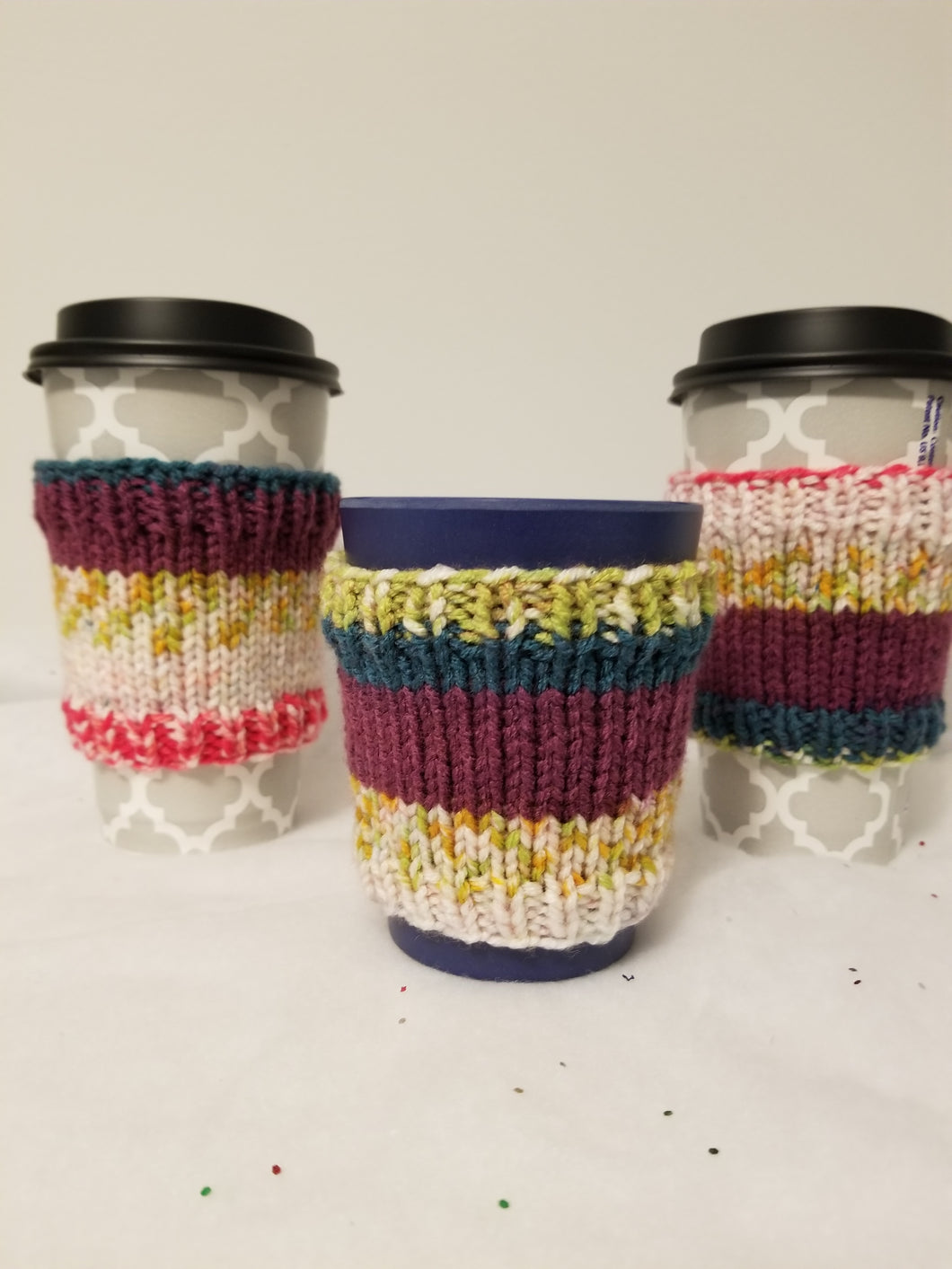 Cup Cuddlers fit 12, 16, 20, & 24 oz cups from your favorite shop, as well as reusable cups. They replace the disposable cardboard sleeve on hot beverages and keep your hands free from moisture and stickiness on cold beverages. And the latest trend? Use them as cuff style bracelets! Cup Cuddlers are $5 each