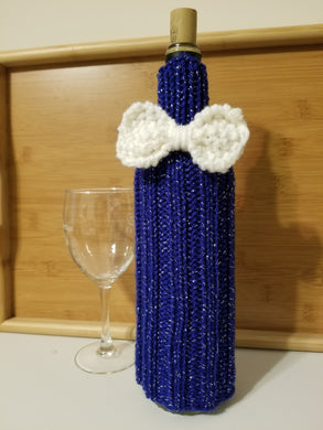 Party Bottle Cover for Wine or Spirits – color: Royalty (a dark blue with silver sparkle) with white bow tie A Party Bottle Cover is a great way to make a gift of wine or spirits extra special. Covers shown on 750 ml bottles but they will stretch to fit a larger bottle with a small amount of the bottle showing at the bottom.  Special orders (team or work colors; shower or wedding gifts) welcome.  Contact Cozy Up via email (CozyUpByClaire@gmail.com) to discuss delivery time.